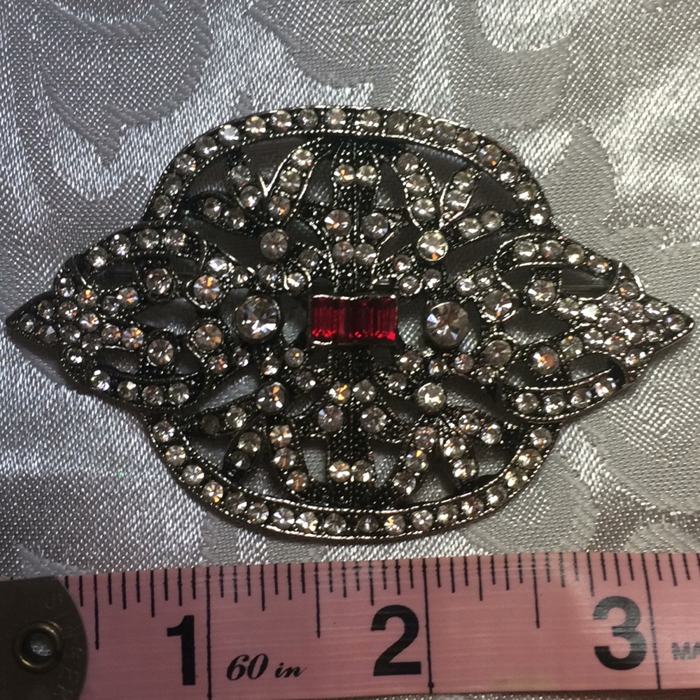 Beautiful rhinestone brooch with red gem center